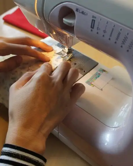 Hands sewing fabric